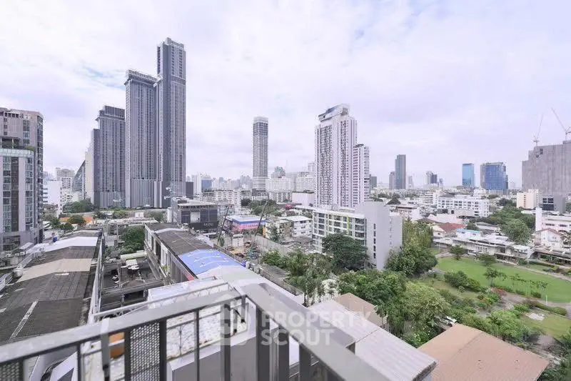 Stunning cityscape view from high-rise balcony overlooking urban skyline.
