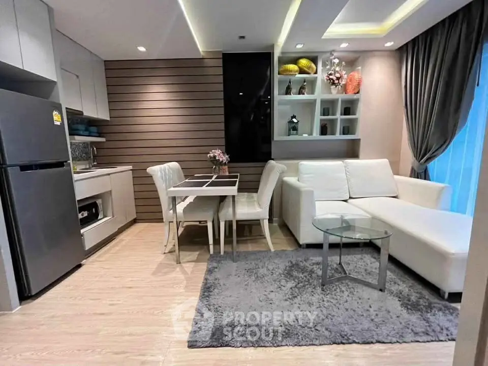 Modern open-layout living room with sleek kitchen and stylish decor