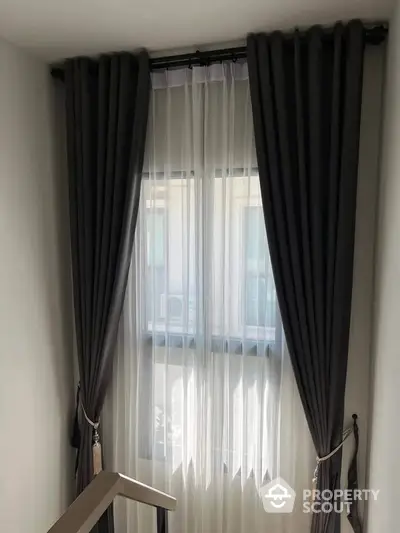 Elegant window with sheer and dark curtains in modern interior