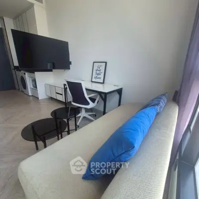 Modern living room with sleek furniture and large TV, perfect for urban living.