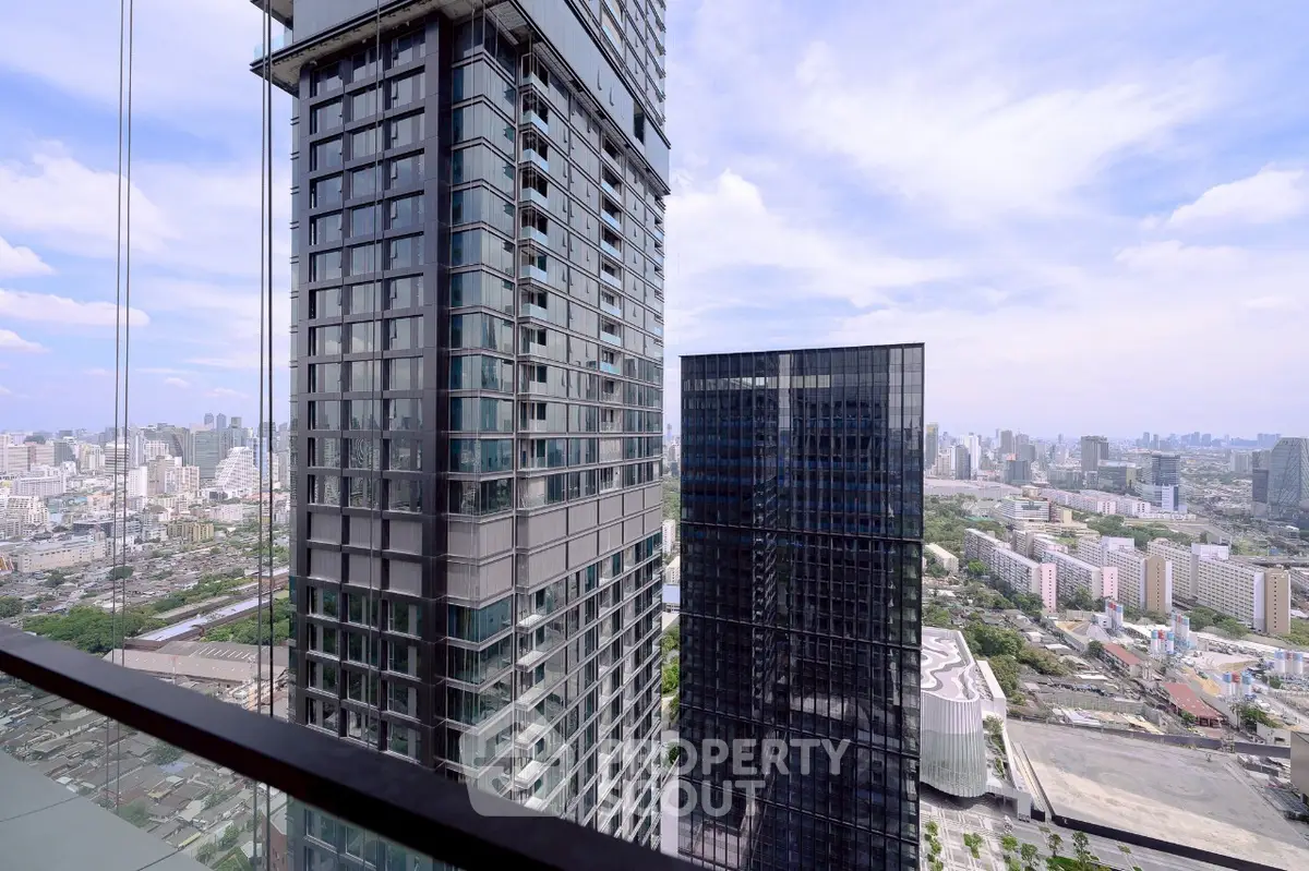 Stunning cityscape view from a high-rise balcony showcasing modern skyscrapers and expansive skyline.