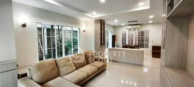 Spacious modern living room with elegant sofa and open kitchen layout