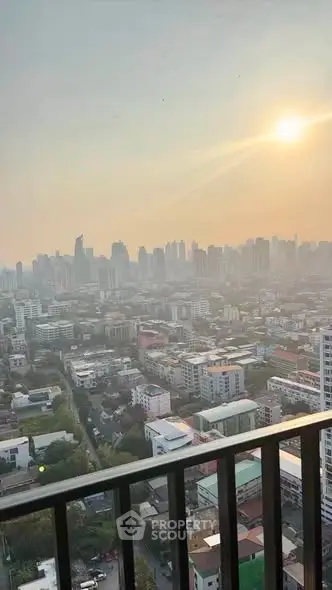 Stunning cityscape view from a high-rise balcony at sunset, showcasing urban skyline and vibrant atmosphere.