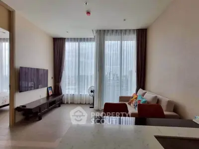 Spacious modern living room with large windows and city view, featuring cozy sofa and wall-mounted TV.