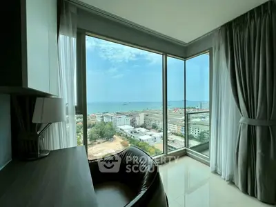 Stunning high-rise view from modern apartment with floor-to-ceiling windows overlooking city and sea.