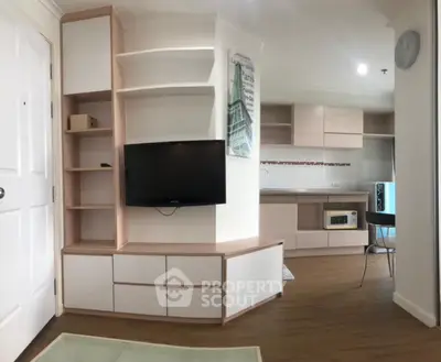 Modern apartment interior with sleek kitchen and built-in TV unit