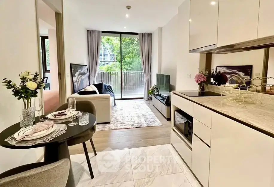Modern open-plan living room and kitchen with elegant decor and balcony view.