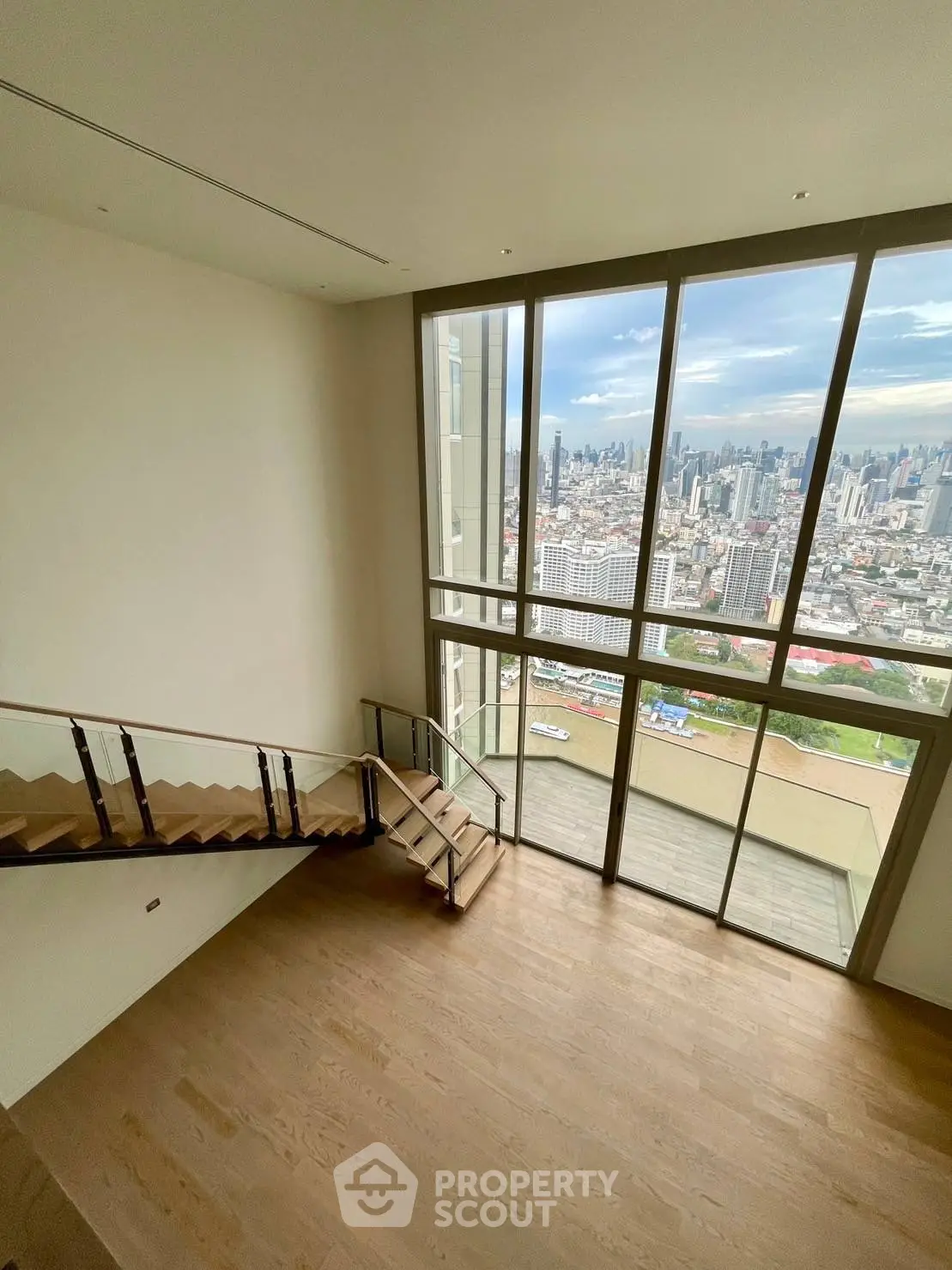 Stunning high-rise apartment with floor-to-ceiling windows and breathtaking city view.