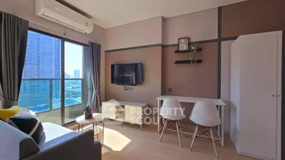 Modern living room with balcony view, featuring stylish furniture and natural light.