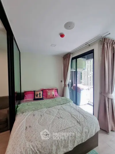 Cozy bedroom with balcony access and modern decor