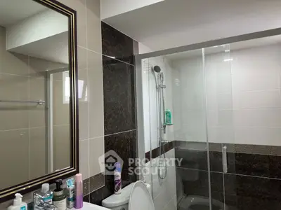 Modern bathroom with glass shower and elegant tile design