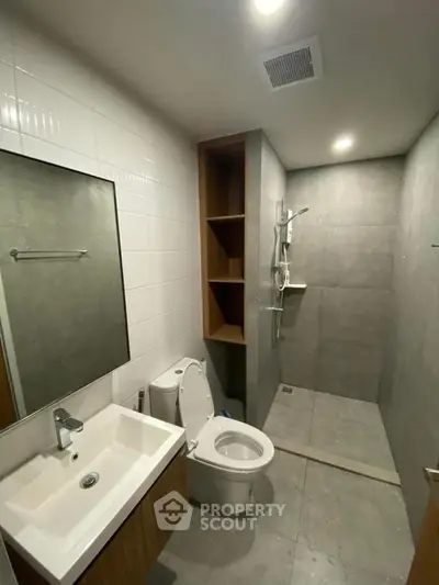 Modern bathroom with sleek fixtures and spacious shower area