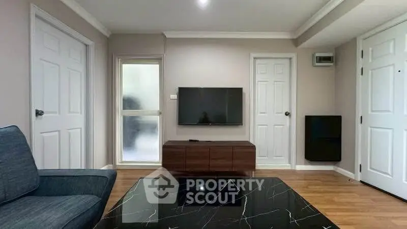 Modern living room with sleek TV setup and stylish furniture