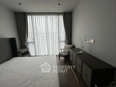 Modern bedroom with floor-to-ceiling windows and elegant furnishings