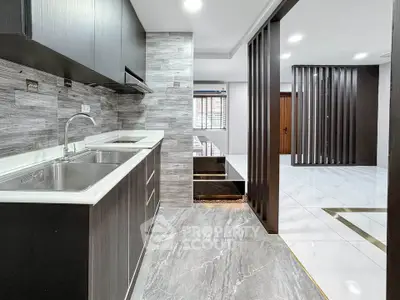 Modern kitchen with sleek cabinetry and open layout in stylish apartment