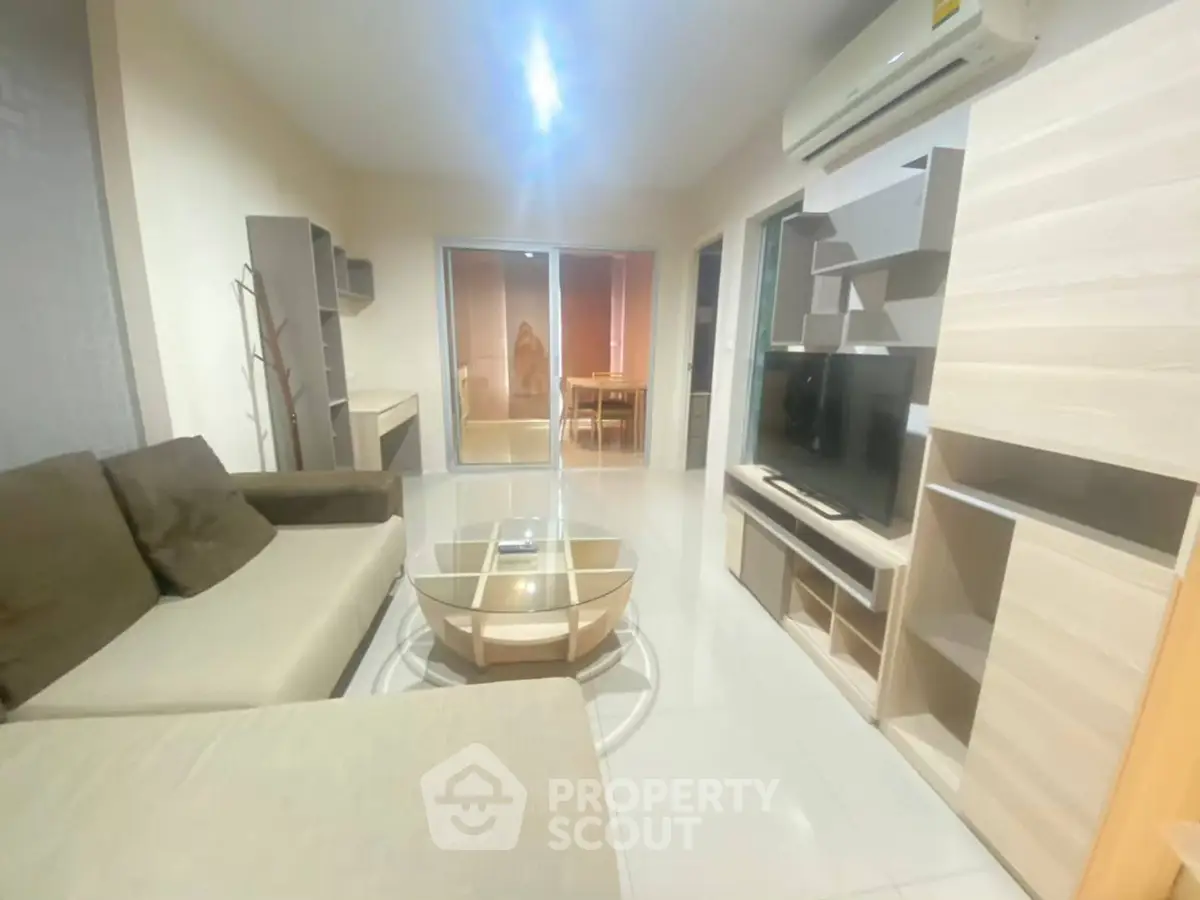 Modern living room with sleek furniture and air conditioning, perfect for comfortable living.