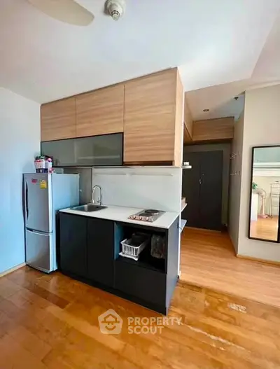 Modern kitchen with sleek cabinetry and compact design in a stylish apartment.