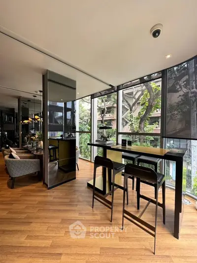 Modern living room with floor-to-ceiling windows and stylish decor