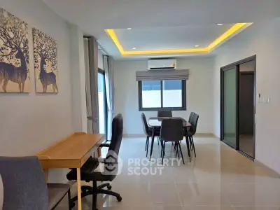 Modern dining area with sleek furniture and ambient lighting in a contemporary apartment.
