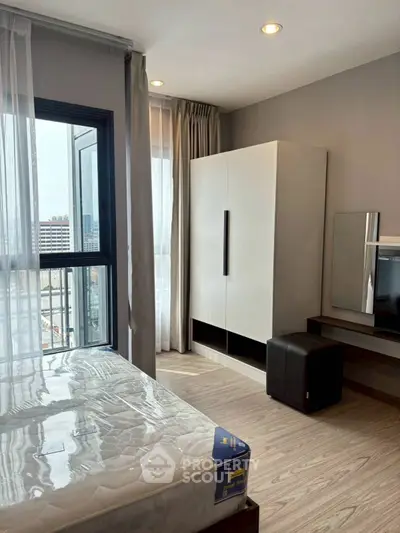 Modern bedroom with large window and stylish furniture in urban apartment