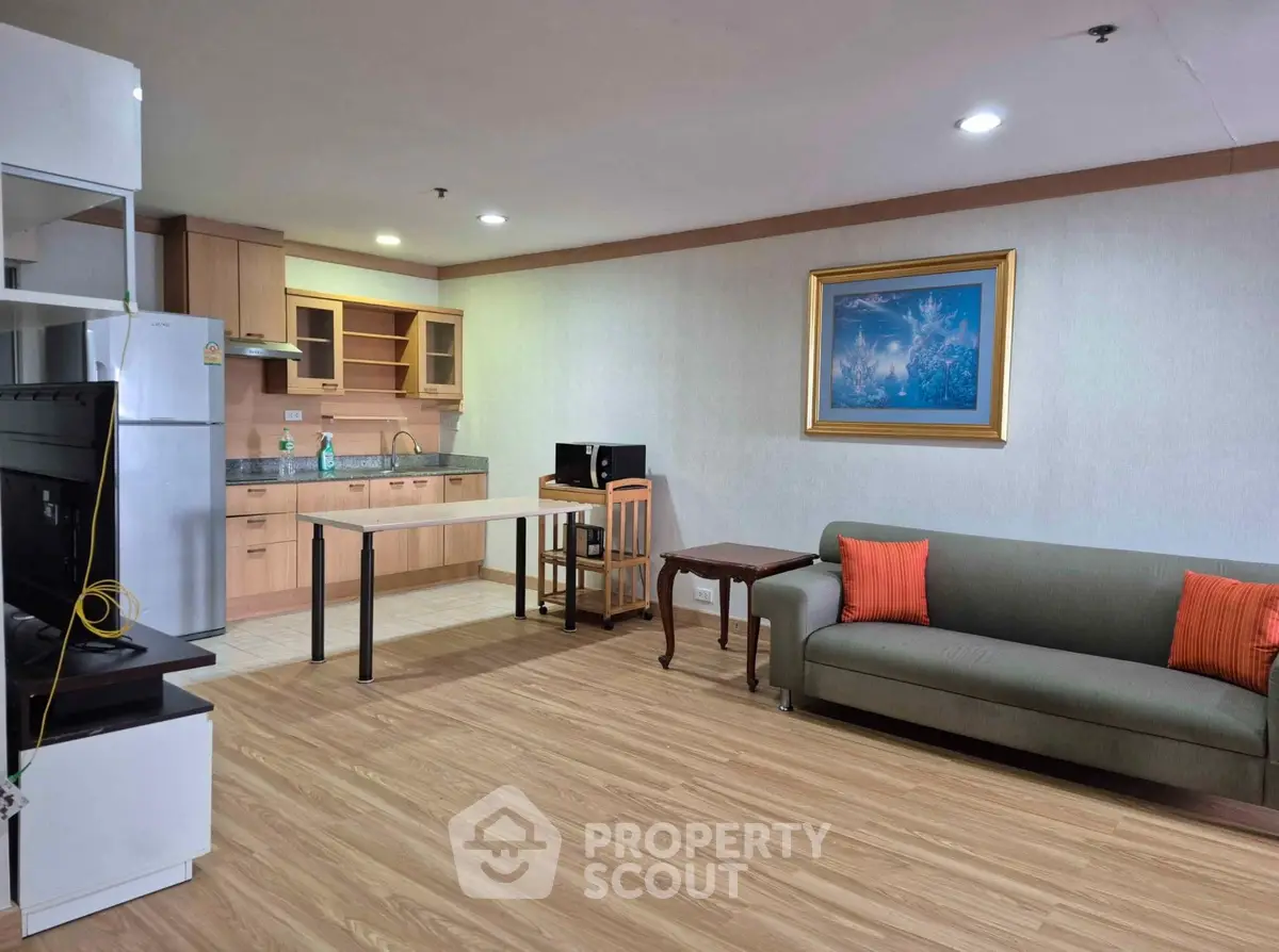 Spacious open-plan living room with modern kitchen and cozy seating area.