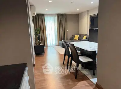 Modern living room with dining area and stylish decor in a cozy apartment setting.