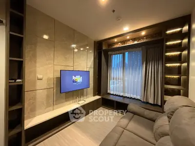 Luxurious living room with modern TV setup and elegant lighting, perfect for relaxation and entertainment.