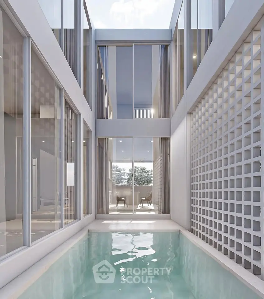 Modern architectural design with sleek pool and glass facade, offering luxury and elegance in urban living.