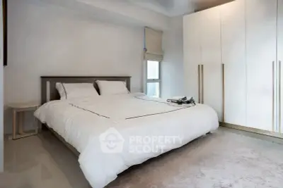 Modern bedroom with sleek design and ample storage space.