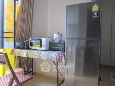 Modern kitchen with stainless steel fridge and appliances in cozy apartment