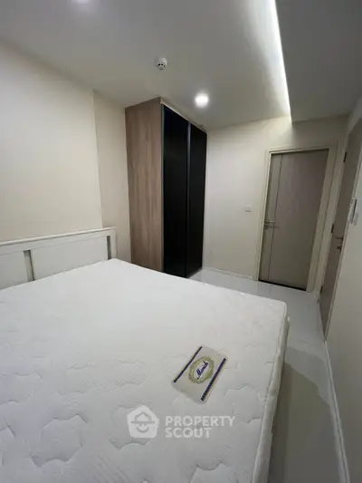 Cozy bedroom with modern wardrobe and comfortable bed in a stylish apartment.