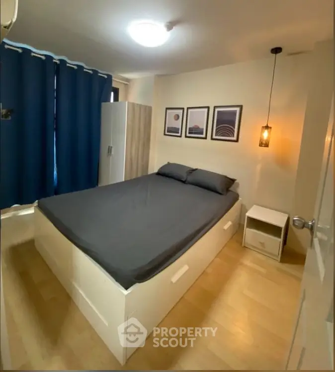Cozy bedroom with modern decor and ample storage in a stylish apartment.