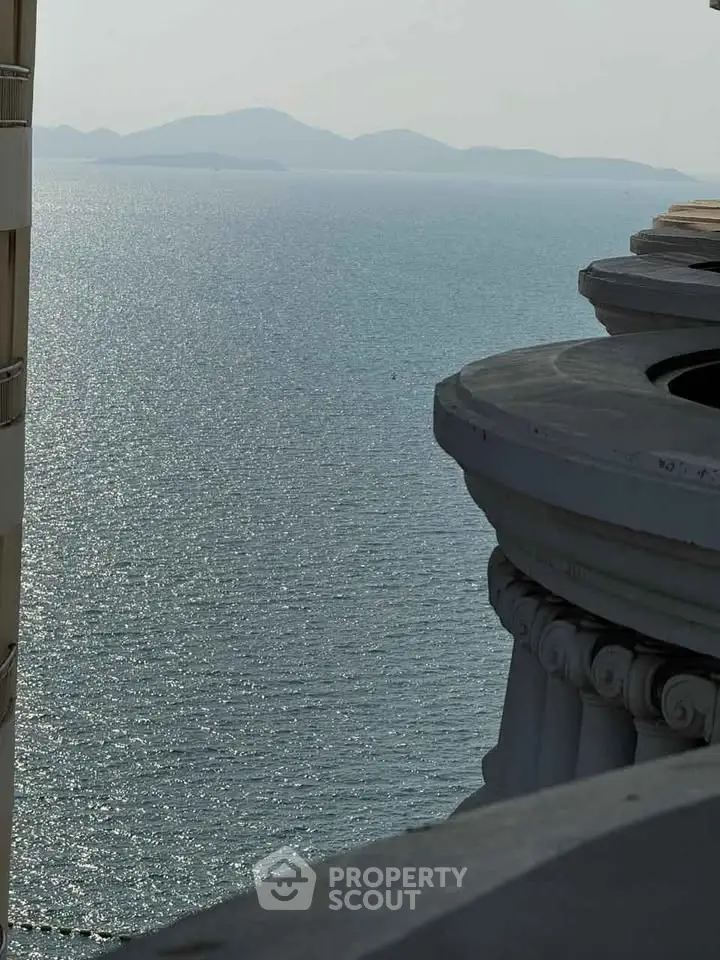Stunning ocean view from a high-rise balcony with classical architectural details.