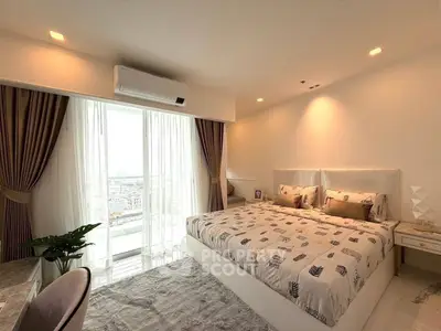 Luxurious bedroom with elegant decor and city view balcony access