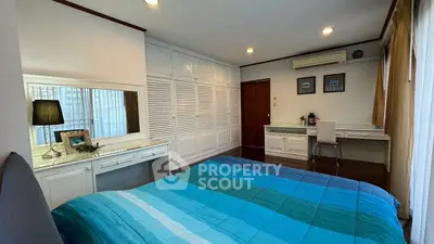 Spacious bedroom with built-in wardrobe and cozy decor