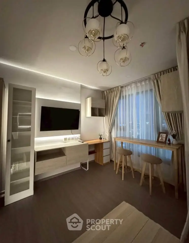 Modern living room with stylish lighting and cozy seating area, perfect for relaxation and entertainment.