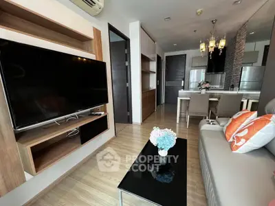 Modern living room with sleek furniture and open kitchen layout in stylish apartment.