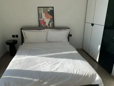Modern bedroom with stylish decor and natural light