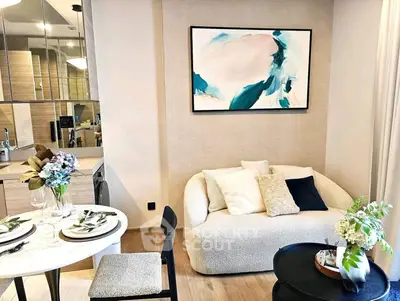 Stylish modern living room with cozy sofa and elegant dining area in open layout apartment.