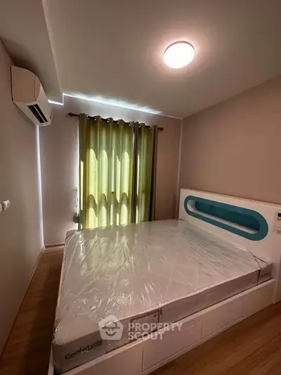 Modern bedroom with air conditioning and stylish bed in cozy apartment.