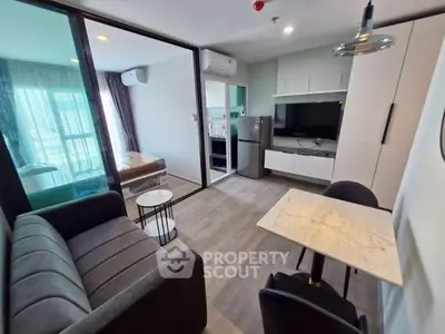 Modern studio apartment with open layout, featuring a cozy living area, compact kitchen, and bedroom with natural light.