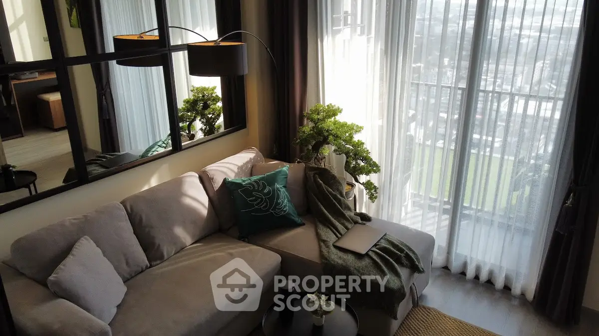 Stylish living room with cozy sofa and panoramic window view