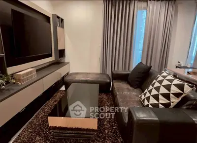 Modern living room with sleek furniture and large TV setup