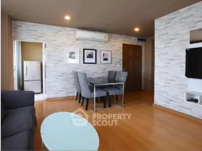 Modern living room with stylish decor and open layout, featuring a cozy dining area and sleek furniture.