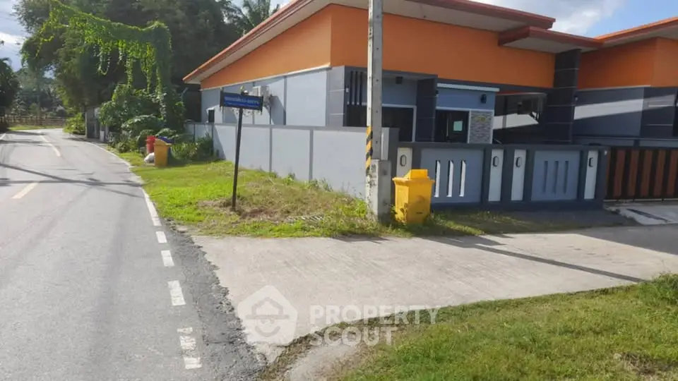 Modern residential building with vibrant orange accents and a well-maintained exterior.