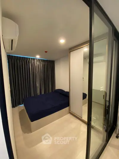 Modern bedroom with glass partition and sleek design in urban apartment
