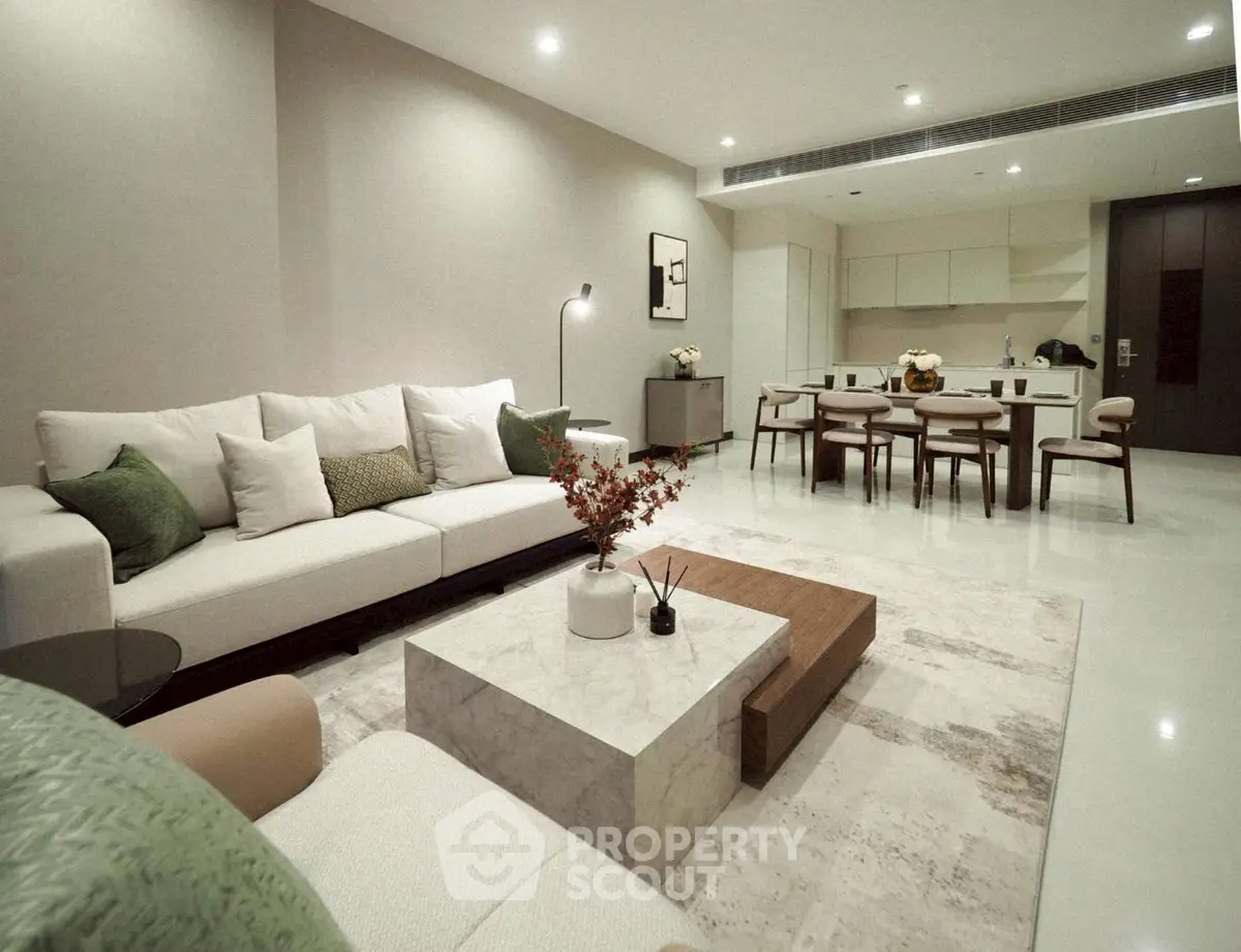 Luxurious open-plan living room with modern decor and elegant dining area