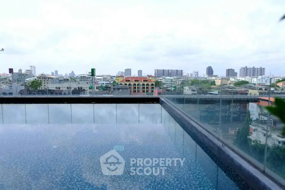 Stunning rooftop pool with panoramic city skyline views, perfect for urban living enthusiasts.