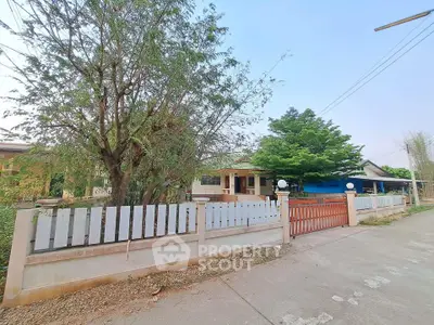 Charming suburban home with spacious front yard and mature trees, perfect for family living.