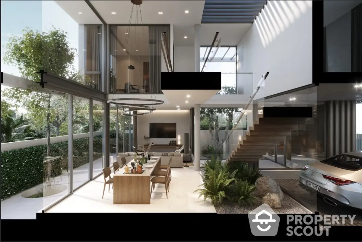 Luxurious open-plan living space with high ceilings, modern staircase, and floor-to-ceiling windows offering an abundance of natural light.